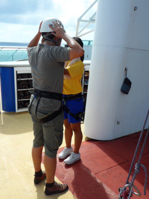 Climber gearing up to scale rock climbing wall - Royal Caribbean Cruise 