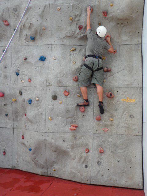 Climber scaling rock climbing wall - Royal Caribbean Cruise Legend of the Seas