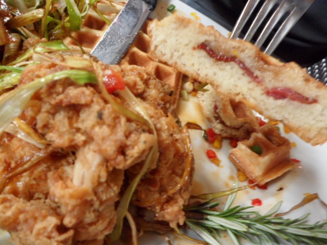 Sage Fried Chicken stacked with bacon waffle, hot maple caramel reduction and crowned with fried leeks (Close Up at Hash House a Go Go Las Vegas)