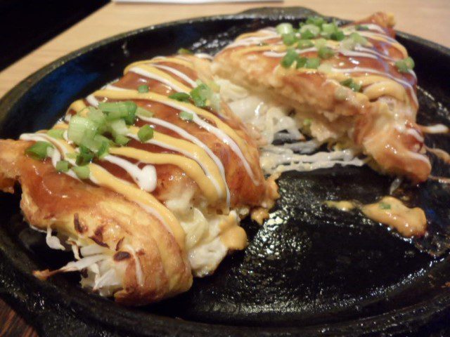 The Tonpeiyaki sliced to reveal the ham and cheese