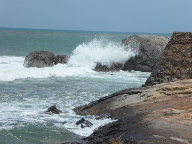 Waves crashing onto huge rocks at Galle Fort