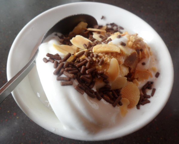 Flow serve ice cream with nuts and chocolate toppings