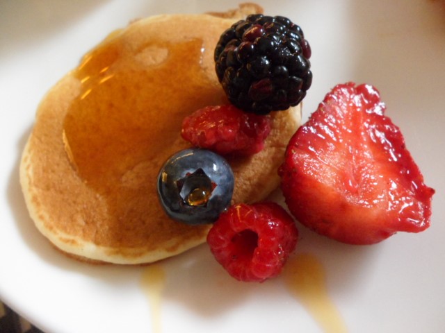 Pancakes with strawberry, raspberries & blueberry topped with maple syrup!
