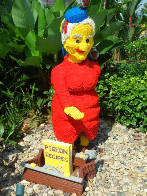 Lady feeding pigeons at Legoland Malaysia