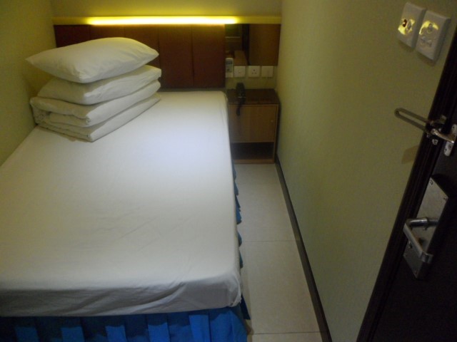 Small bed beside the entrance to the room