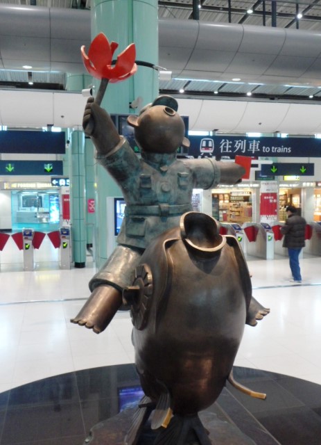 Statue on the way out of Hong Kong immigration enroute back