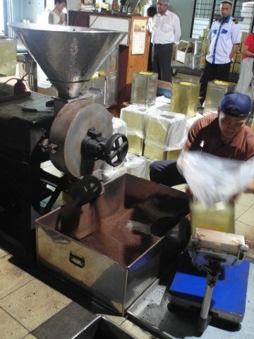 Coffee powder being packed into tins