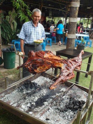 H.E. High Commissioner of Malaysia Dato Husni Zai Yaacob looking on at the roasted lamb