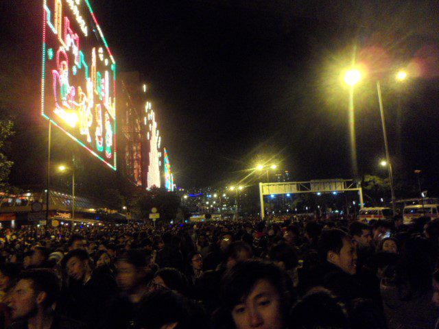 Crowd waiting for fireworks and countdown Victoria Harbour Hong Kong