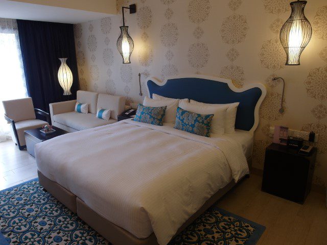 Elegant blue and inviting bed of Club Room Village Hotel Katong