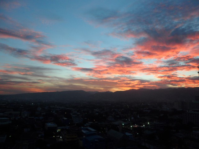Sunset from our room at Ramos Tower City Suites orangey sky