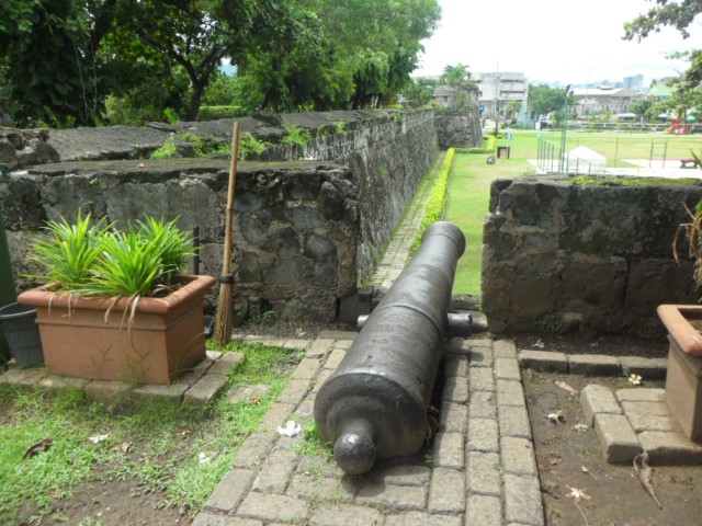Cannon in fort with the remnants of the wall