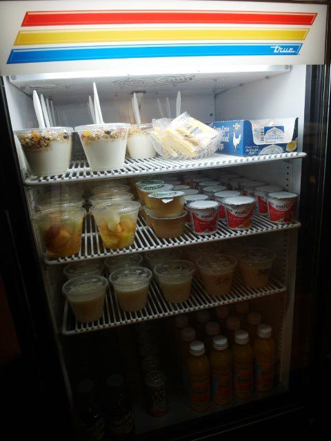 Yoghurt, juice, milk, soy milk, parfait and fruits in the fridge