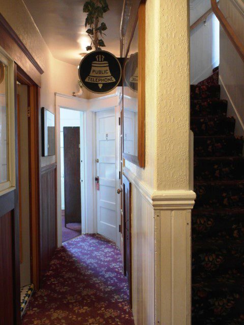 Pay phone with a retro looking sign above (San Remo Hotel San Francisco)