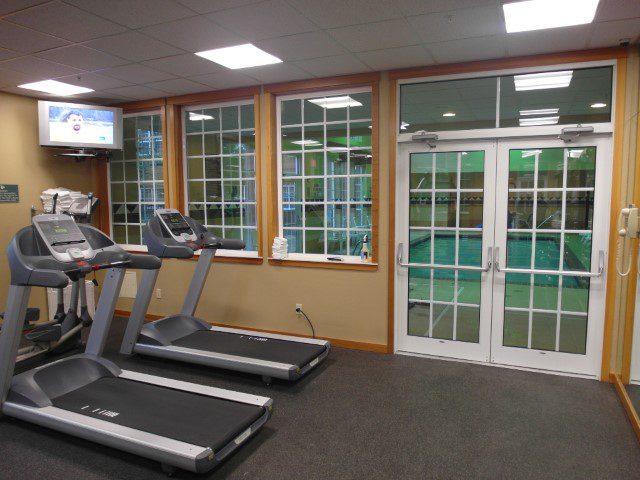 Gym at Heathman Lodge overlooking the indoor heated pool