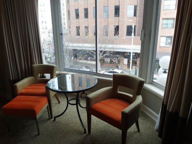 Bright orange arm chair with views of the city streets from Inn at the Market Seattle