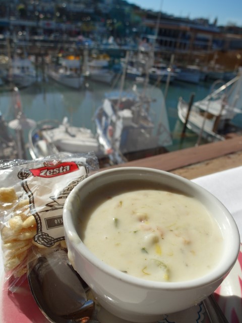 Clam Chowder in a cup with view of the wharf and boats (Fisherman's Grotto Restaurant San Francisco Fisherman's Wharf)