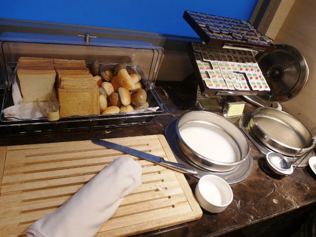 Selection of breads buns porridge and hot soy milk