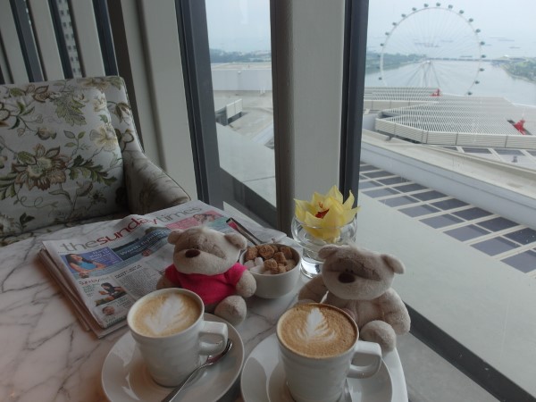 Latte and Sunday Times with views of the Singapore Flyer in the background