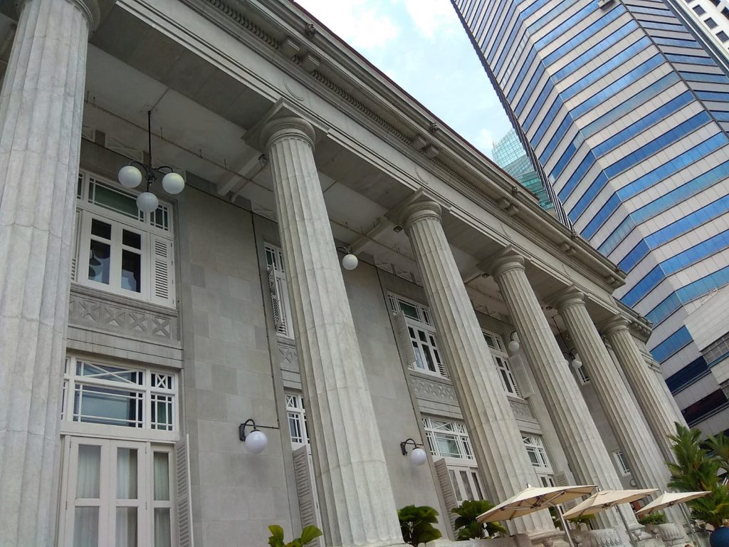 Tall colonial-era pillars as seen from the swimming pool of the Fullerton Singapore Hotel