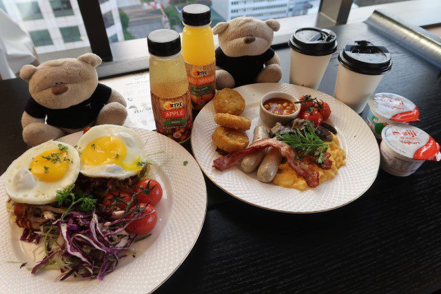 Qin Breakfast and Chef's Special (Asian style pulled pork with shredded cucumber on English muffin) along with juices and latte for in-room breakfast at the Clan Hotel Singapore