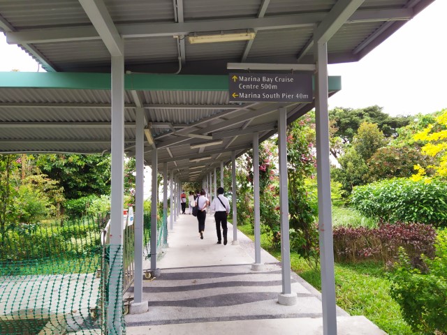 Walking along sheltered walkway from Marina South Pier MRT Station to Marina Bay Cruise Centre