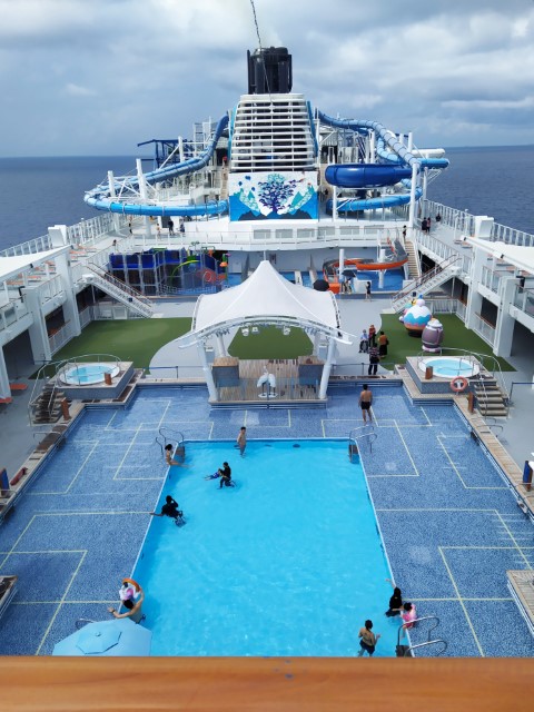 View of Swimming pool and slides from Deck 18 of World Dream Cruise to Nowhere