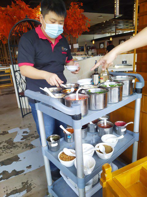 Choosing the condiments for our dipping sauce at Jianghu Hotpot