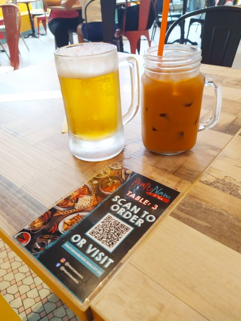 Scan to order. Here, $5 Sapporo draft beer and Red Thai Milk Tea