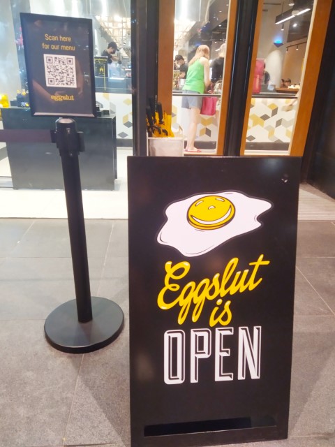 Entrance of Eggslut Singapore ("Eggslut is Open" sign)