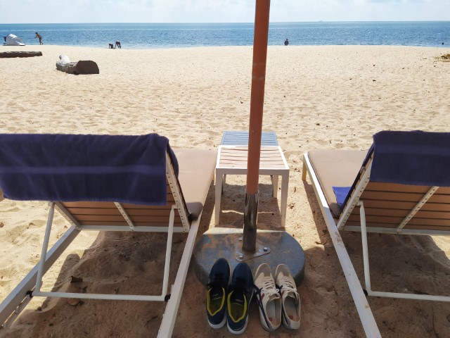 Beach chair and umbrella next to Westin Desaru Coast Resort