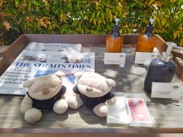 Sun block, body lotion and newspapers/magazines available next to the swimming pool of Mandarin Oriental Singapore Hotel