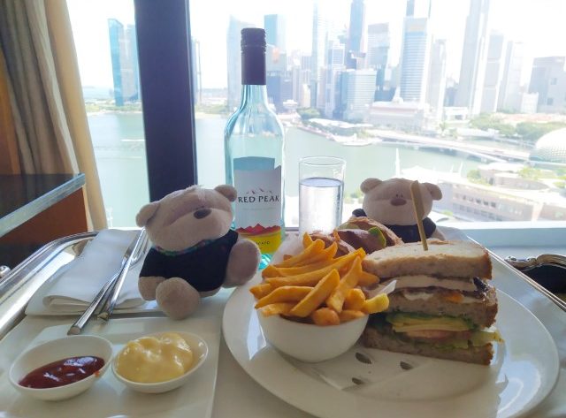 Enjoying Mandarin Oriental Club Sandwich with wine while enjoying views of Marina Bay