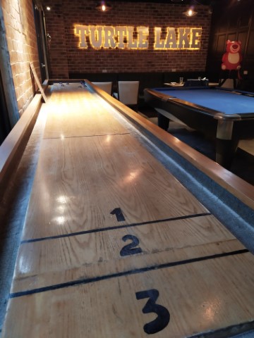 Table shuffleboard and pool table at Turtle Lake Brewing Company Hanoi
