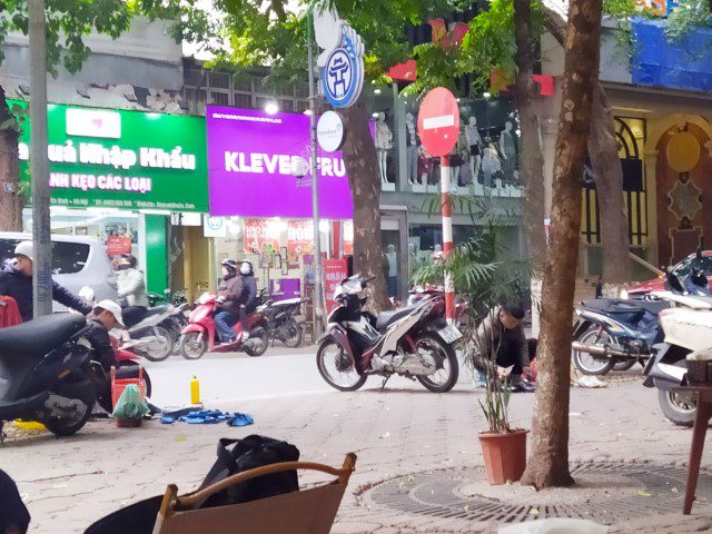 Our pair of shoes left by the roadside by shoeshine cleaners in Hanoi