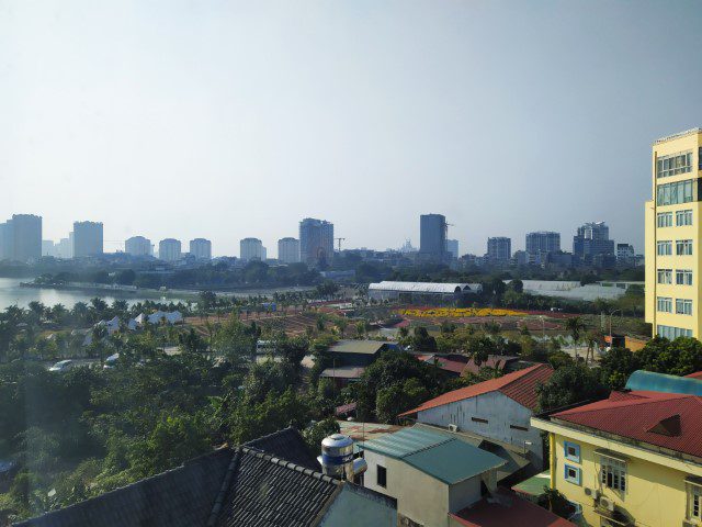 View of the flower fields at Cafe Thung Lũng Hoa with Ho Tay Lake in the background