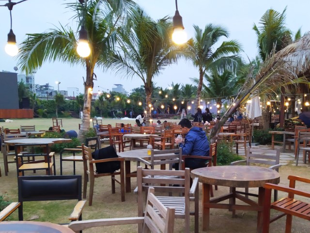 Green open space and large screen TVs of Cafe Thung Lũng Hoa Hanoi Flower Garden