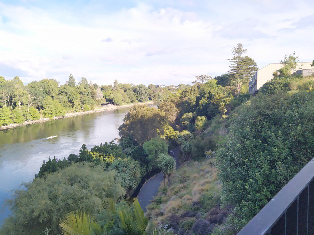 Canoeist on Waikato River as seen from Hamilton Central New Zealand