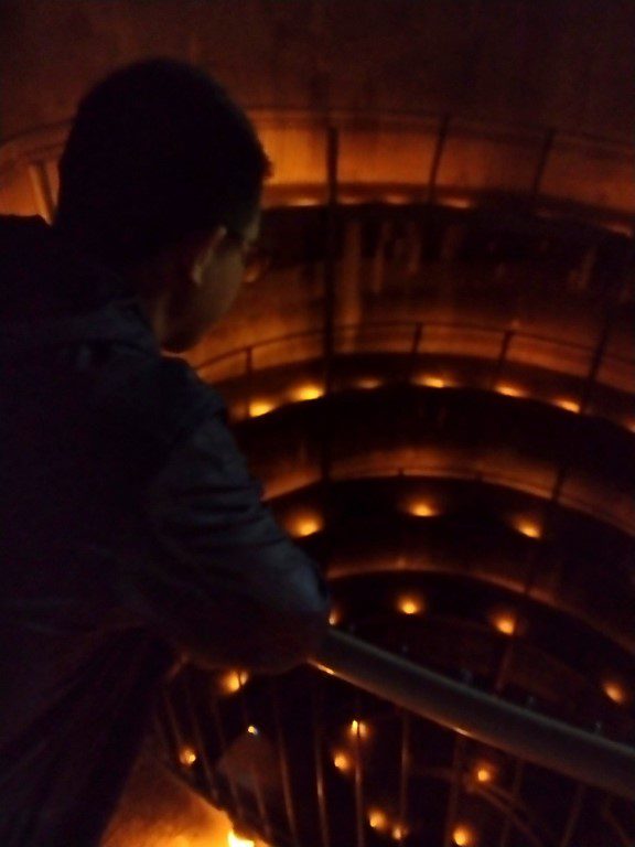 Tom staring down into the descent to Waitomo Glowworm Caves