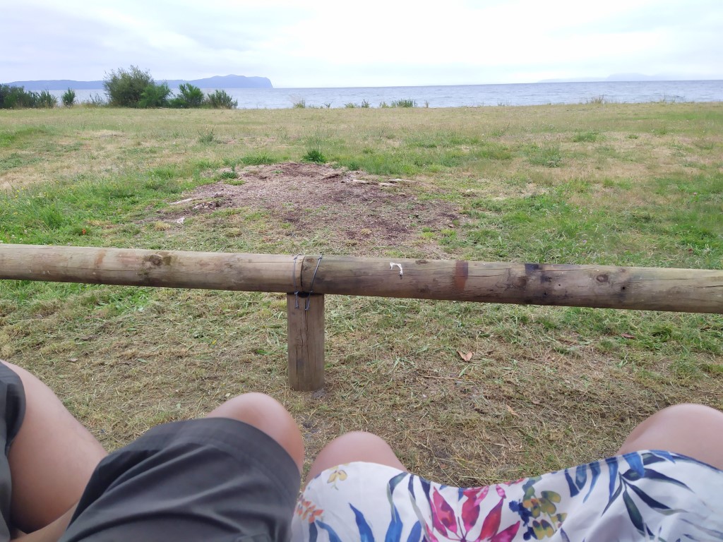 Sitting in our boot facing  Lake Taupo from Waitoke Beach