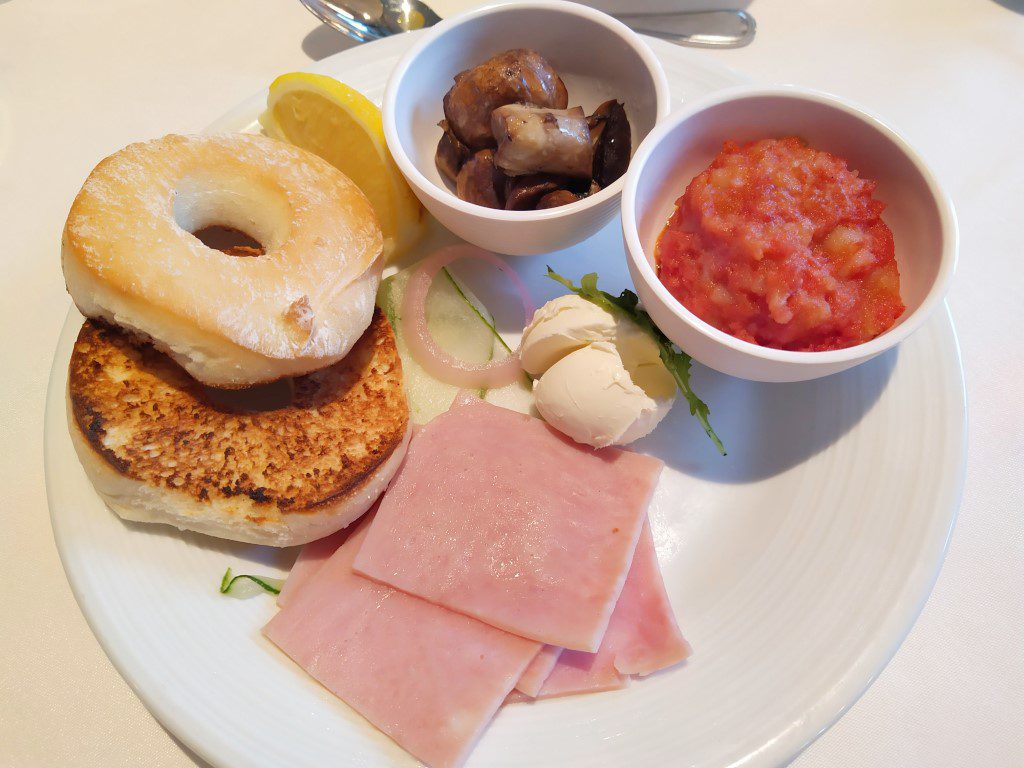 Spectrum of the Seas Main Dining Room Breakfast Bagel and Ham (Royal Caribbean Cruise) along with mimosa