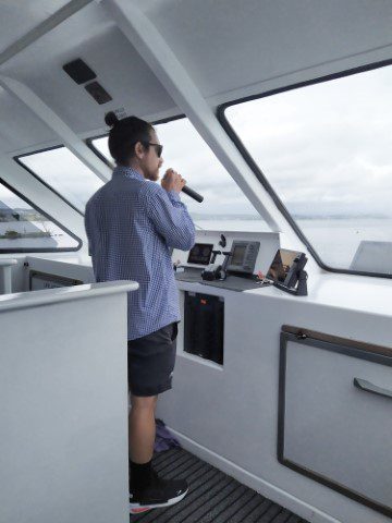 Captain giving live narration during Chris Jolly Maori Rock Carving Cruise Lake Taupo