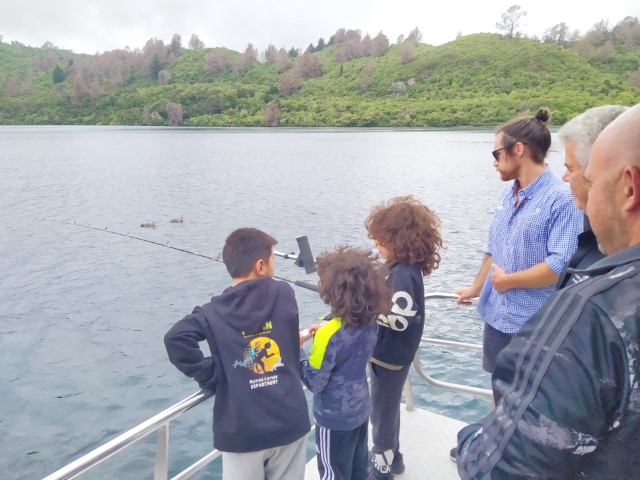 Trout fishing demonstration during Chris Jolly Maori Cave Carving Cruise