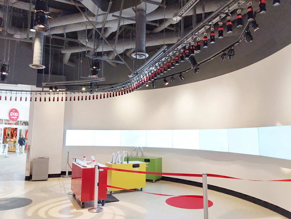 Coca-Cola bottles moving overhead at Taste it! of World of Coca-Cola