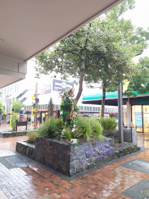 Busker dressed as Christmas Tree along Cuba Street Wellington New Zealand